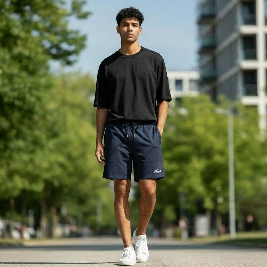Swift Gear navy athletic performance shorts with drawstring elastic waistband and side pockets, worn by a man.